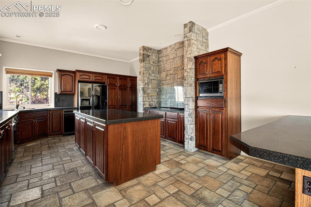 13950 Herring Road Colorado Springs, CO 80908 - Photo 12 of 50 a kitchen with stainless steel appliances granite countertop a refrigerator and a stove