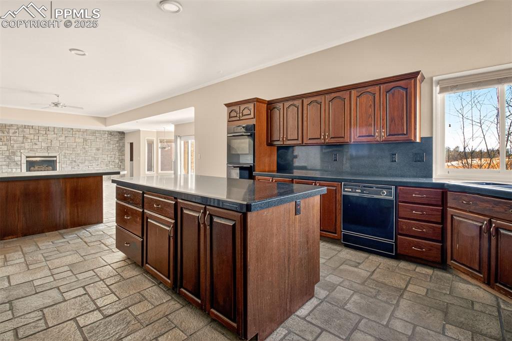 13950 Herring Road Colorado Springs, CO 80908 - Photo 14 of 50 a kitchen with stainless steel appliances granite countertop a stove a sink dishwasher and a refrigerator
