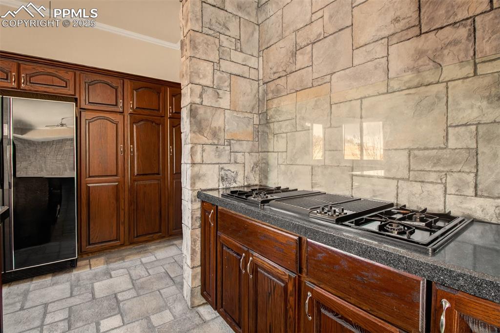 13950 Herring Road Colorado Springs, CO 80908 - Photo 16 of 50 a kitchen with granite countertop a stove and refrigerator