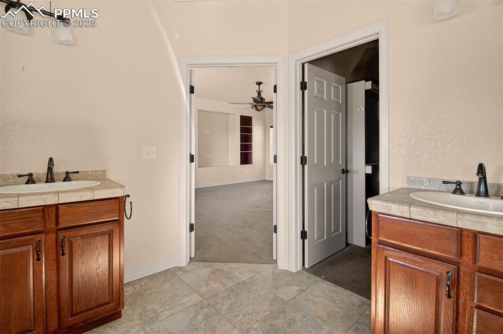13950 Herring Road Colorado Springs, CO 80908 - Photo 22 of 50 a room that has a sink and a mirror
