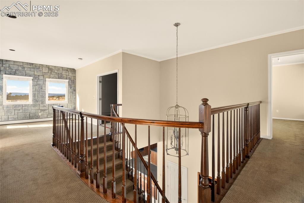 13950 Herring Road Colorado Springs, CO 80908 - Photo 26 of 50 a view of staircase with wooden floor and windows
