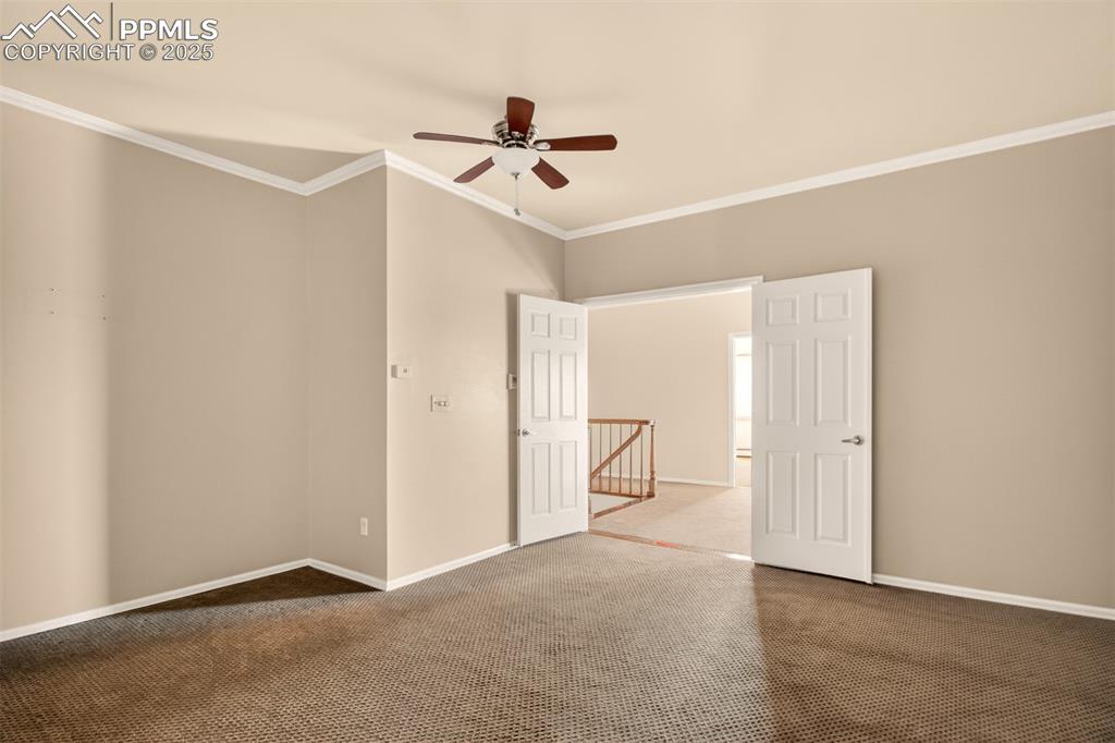13950 Herring Road Colorado Springs, CO 80908 - Photo 29 of 50 a view of a livingroom with a ceiling fan and entryway