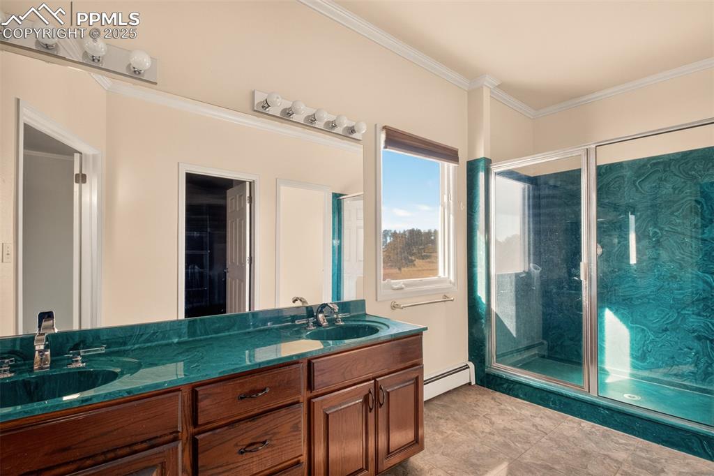 13950 Herring Road Colorado Springs, CO 80908 - Photo 30 of 50 a spacious bathroom with a granite countertop sink and a large mirror