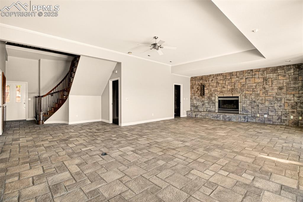 13950 Herring Road Colorado Springs, CO 80908 - Photo 6 of 50 a view of an empty room with wooden floor and a fireplace
