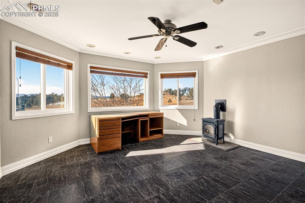 13950 Herring Road Colorado Springs, CO 80908 - Photo 10 of 50 a living room with furniture a window and a fireplace