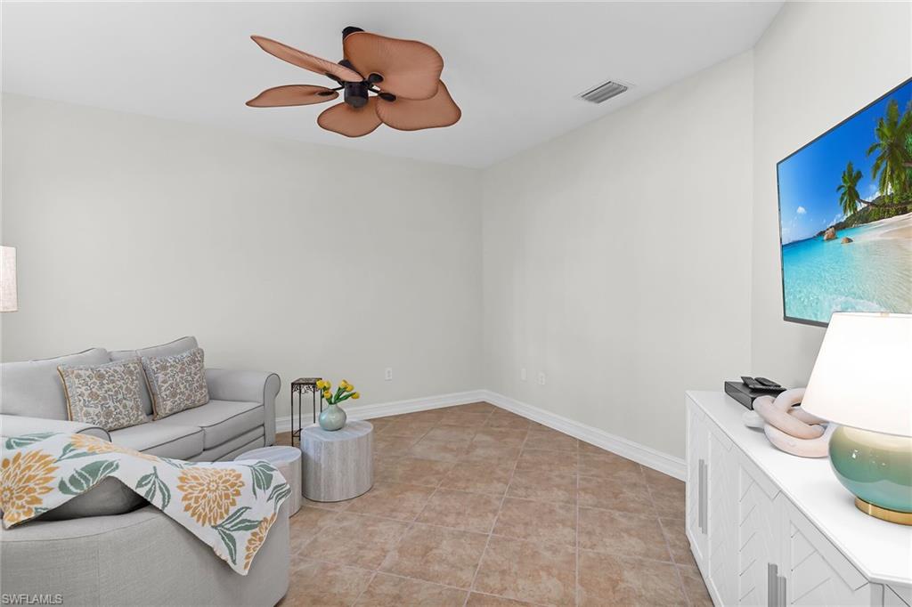 1286 Rialto Way, Unit 9202 Naples, FL 34114 - Photo 24 of 49 Den featuring tile flooring, a ceiling fan, and multiple windows.