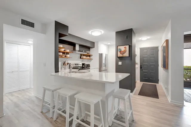a large kitchen with a table and chairs