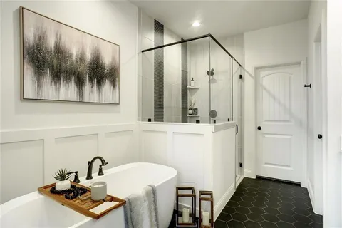 a bathroom with a sink and mirror with bathtub