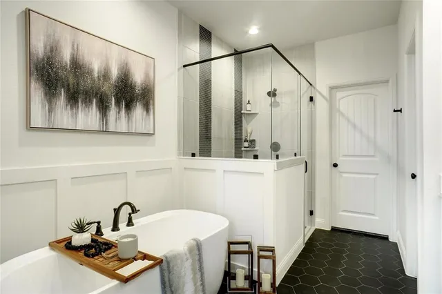 a bathroom with a sink and mirror with bathtub