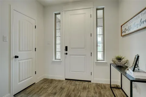 a view of an entryway with wooden floor