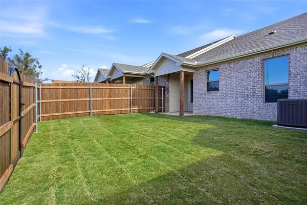 a view of a house with a yard and sitting area
