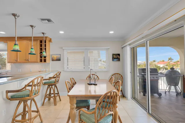 a view of a dining room with furniture and a floor to ceiling window