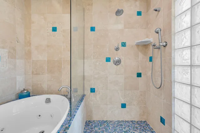 a bathroom with a bathtub and shower