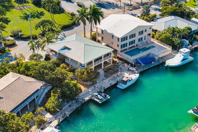 an aerial view of a house with a garden and swimming pool