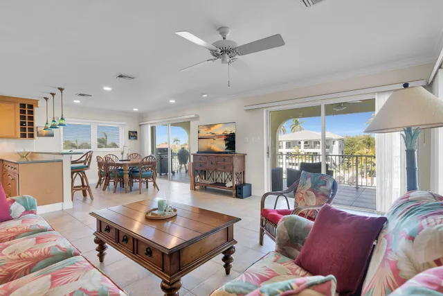 a living room with furniture a table and a large window