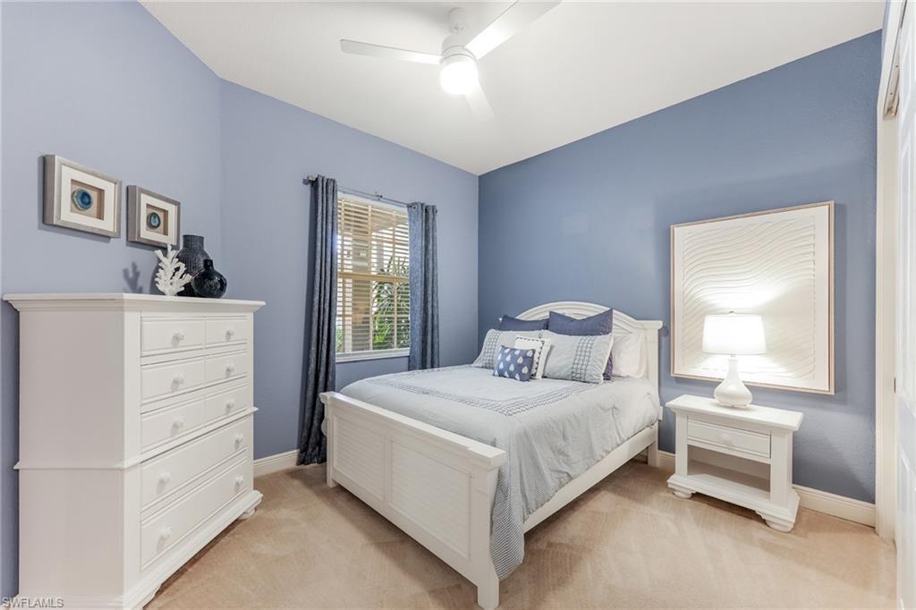 7849 Hawthorne Drive, Unit 802 Naples, FL 34113 - Photo 20 of 49 Carpeted bedroom with ceiling fan