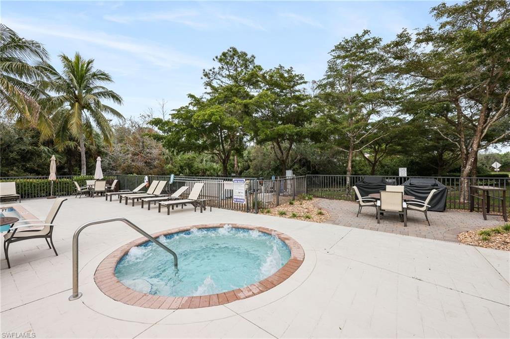 7849 Hawthorne Drive, Unit 802 Naples, FL 34113 - Photo 43 of 49 View of swimming pool featuring a community hot tub, area for grilling, and a patio