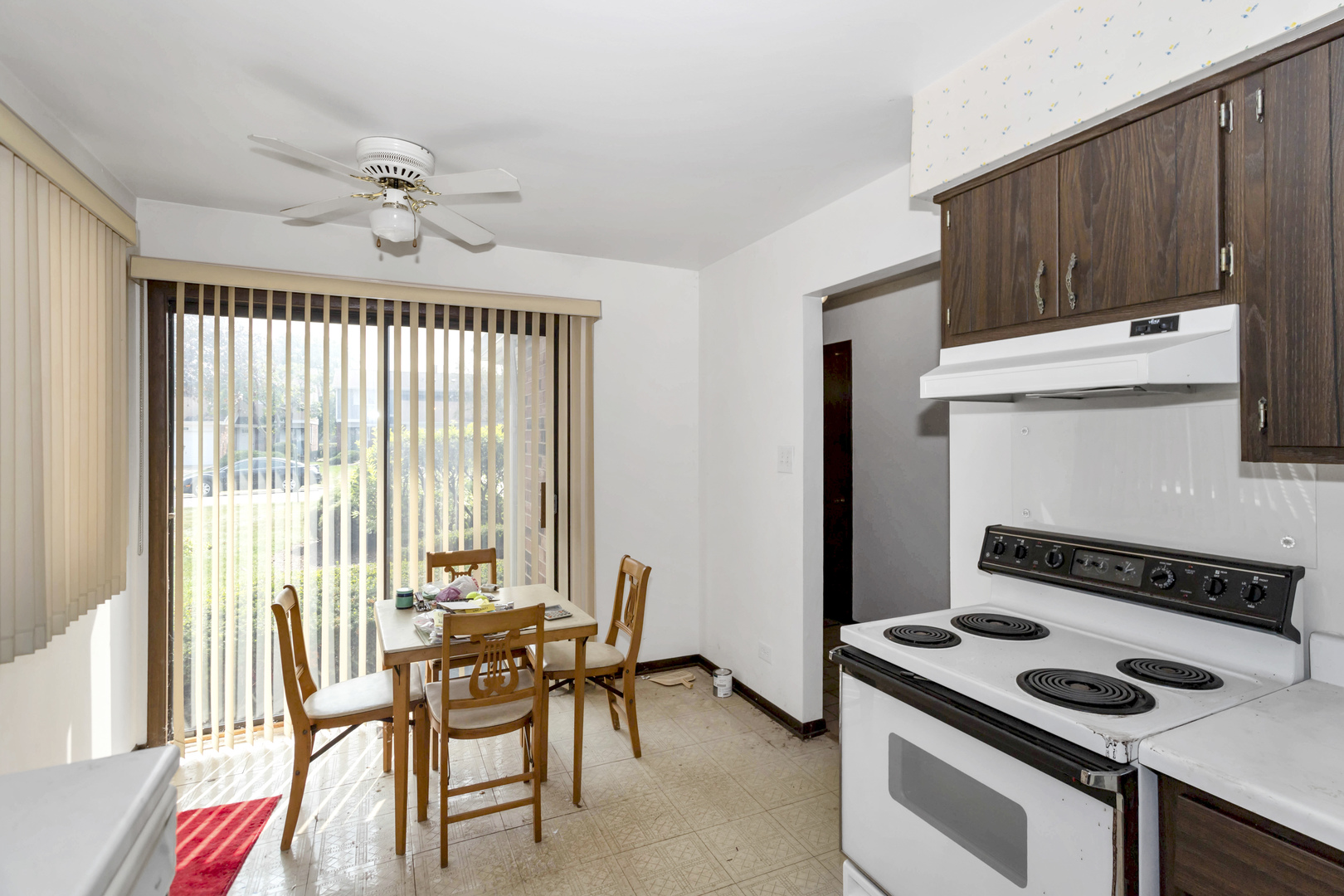1155 Leicester Court Wheaton, IL 60189 - Photo 15 of 30 a kitchen with a stove a refrigerator and wooden floor