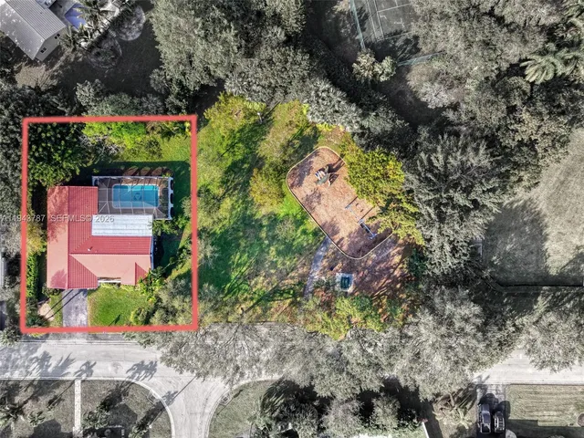 an aerial view of a house with a yard