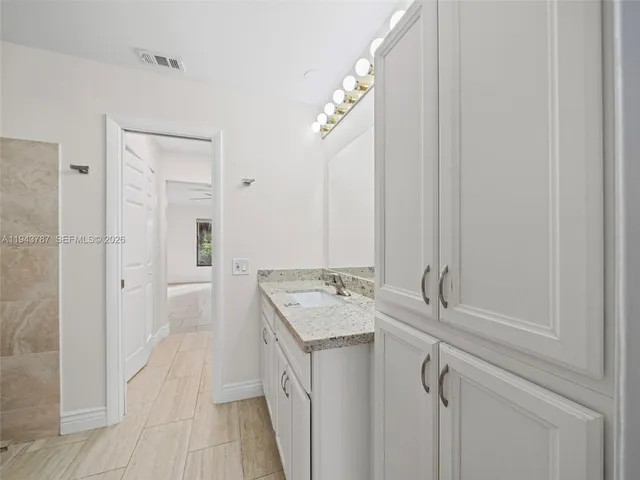 an empty room with windows and closet