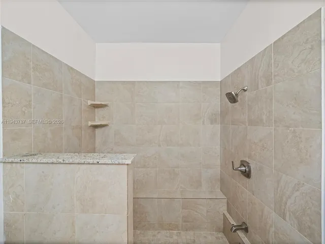 a large kitchen with stainless steel appliances granite countertop a stove and a sink