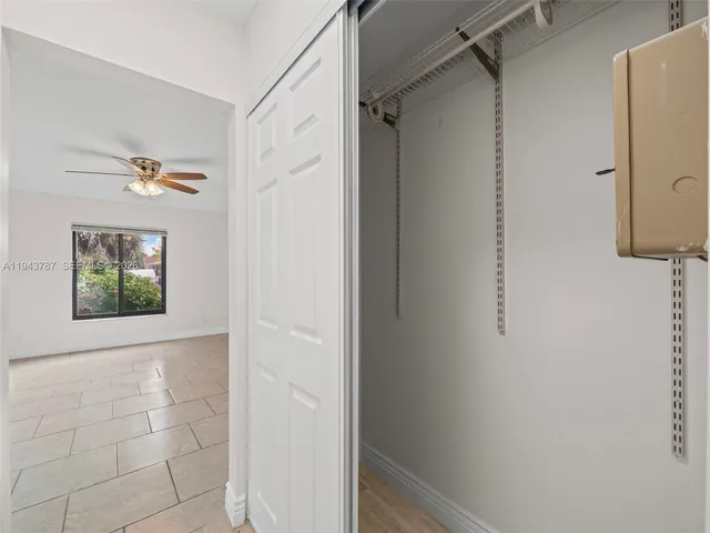 a view of a kitchen with a center island and stainless steel appliances