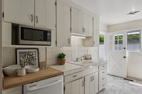 a kitchen with stainless steel appliances white cabinets and a sink
