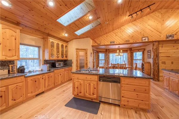 a kitchen with counter top space and wooden floor