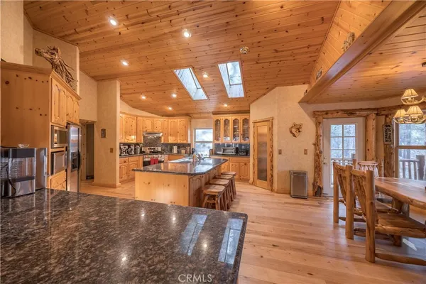 a kitchen with stainless steel appliances granite countertop a sink and cabinets