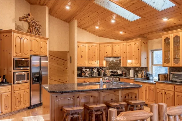 a large kitchen with a table and chairs