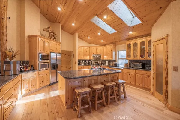 a kitchen with lots of counter top space and furniture