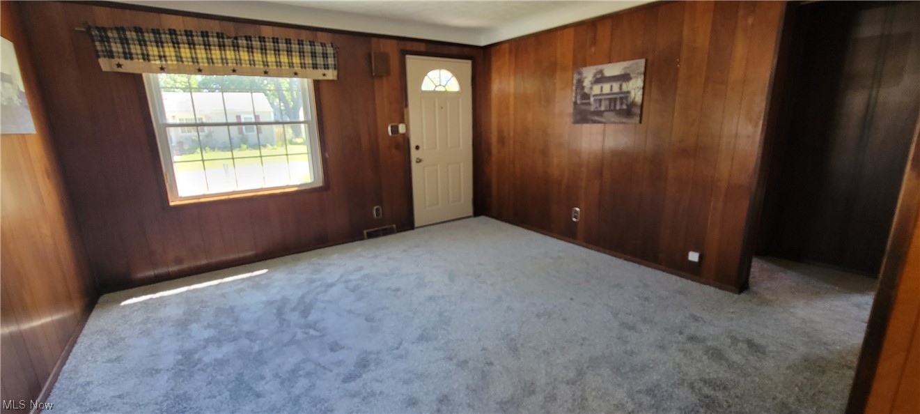 33703 Guilbert Road Eastlake, OH 44095 - Photo 14 of 32 Carpeted empty room featuring wood walls