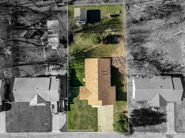 an aerial view of a house with a yard