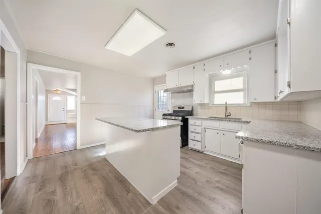 a kitchen with a refrigerator and a sink