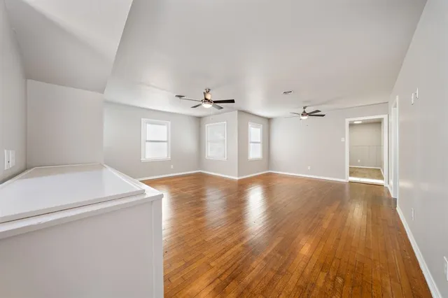 a view of a room with wooden floor and window