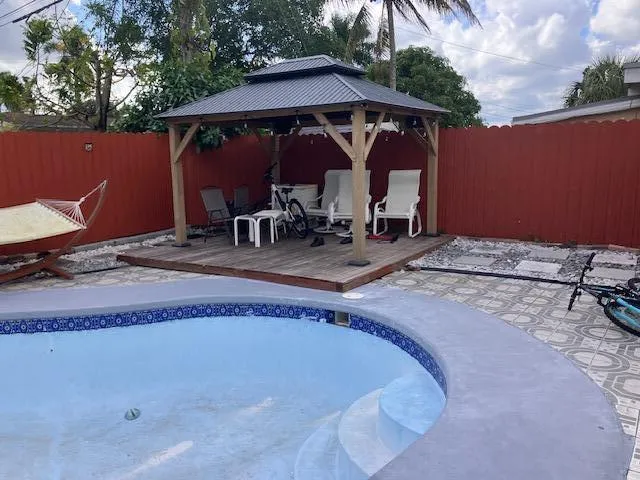 a view of roof deck with table and chairs under an umbrella
