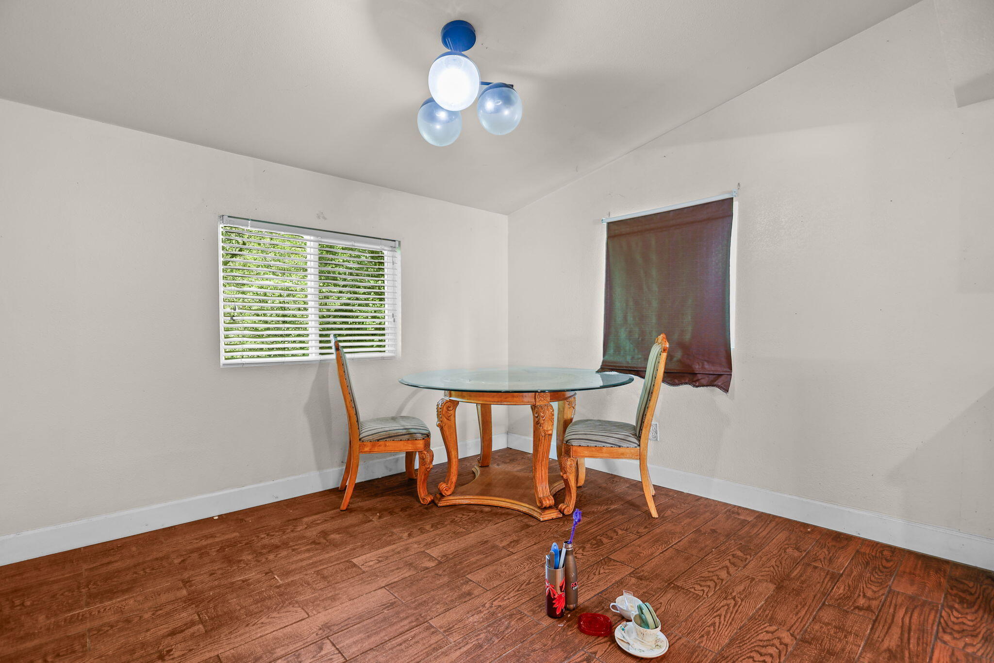 18855 Turnell Road Cottonwood, CA 96022 - Photo 5 of 34 a view of a room with wooden floor a ceiling fan and windows