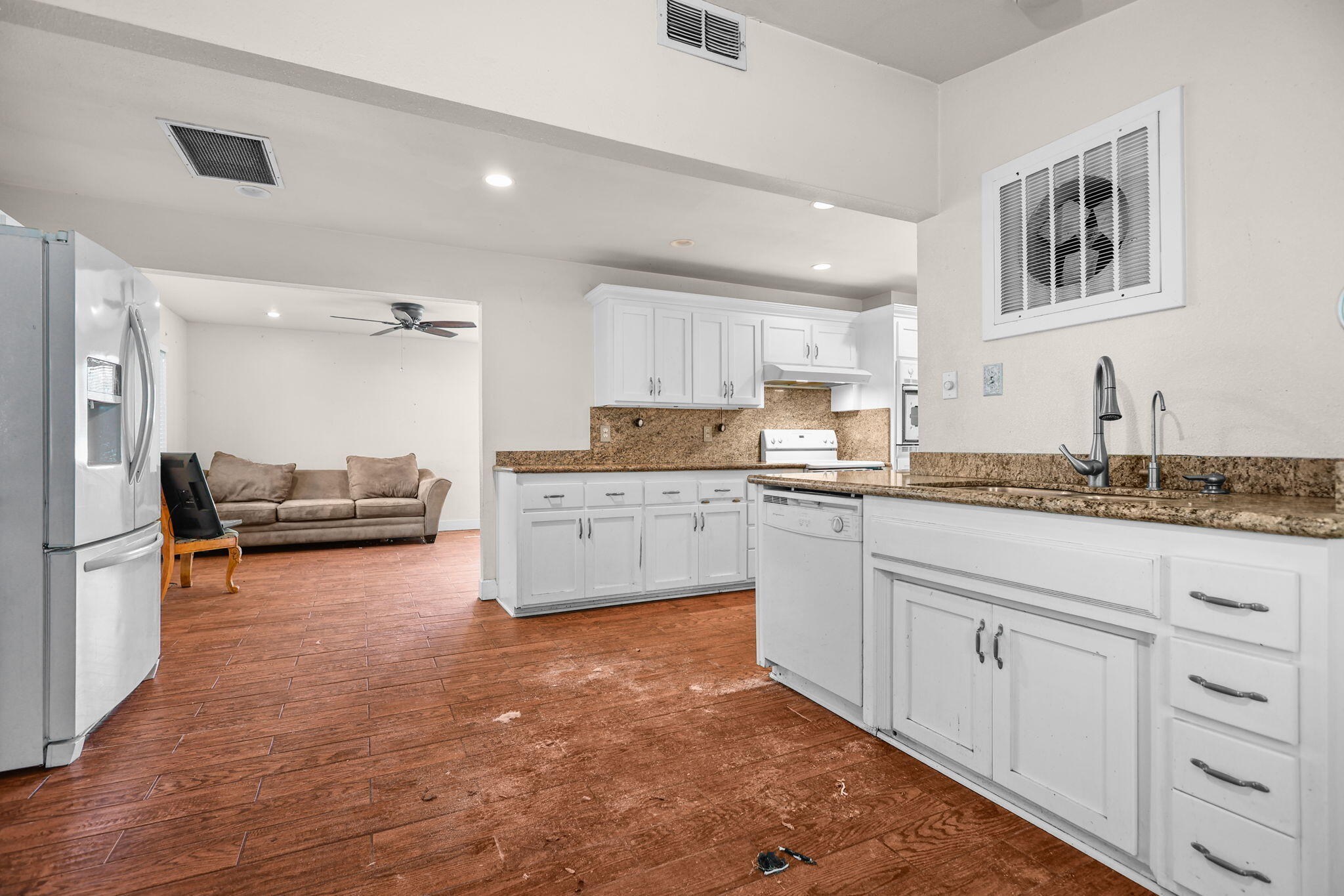 18855 Turnell Road Cottonwood, CA 96022 - Photo 6 of 34 a kitchen with granite countertop a stove a sink and a refrigerator