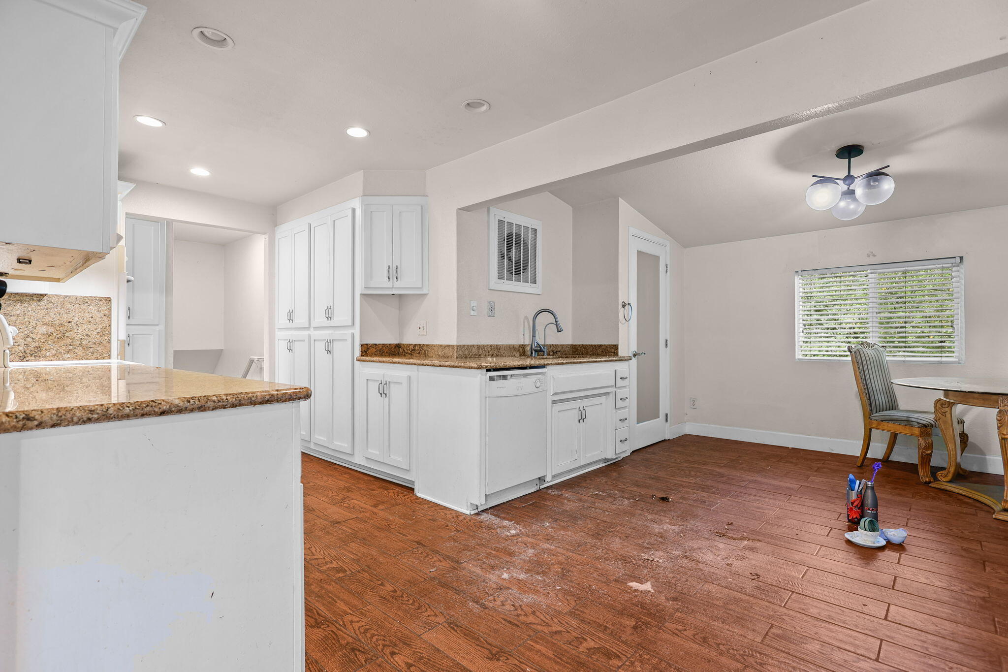 18855 Turnell Road Cottonwood, CA 96022 - Photo 9 of 34 a kitchen with granite countertop white cabinets and wooden floor