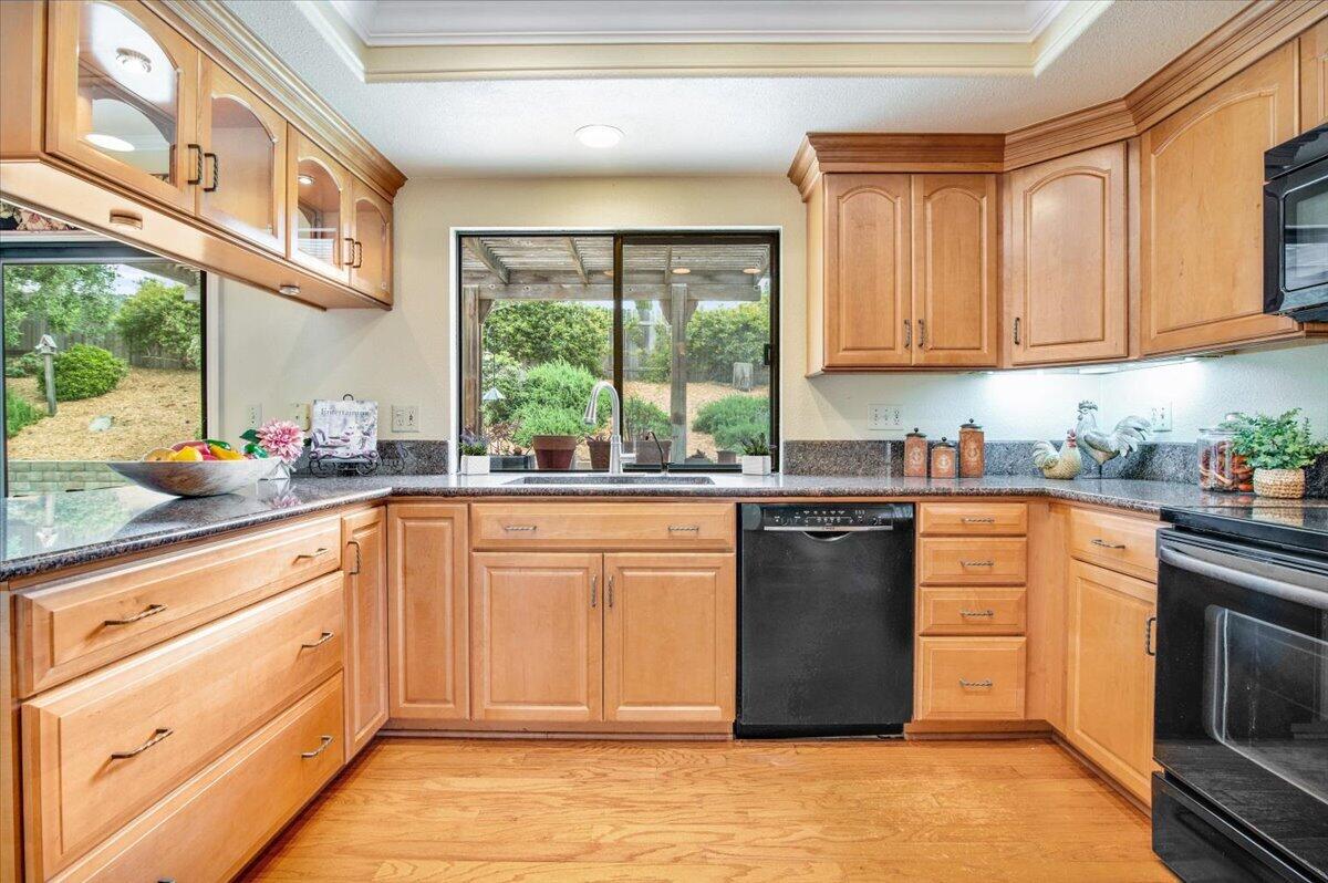 4603 Falcon Drive Lompoc, CA 93436 - Photo 11 of 45 a kitchen with stainless steel appliances granite countertop a refrigerator a sink dishwasher a stove and white countertops with wooden floor