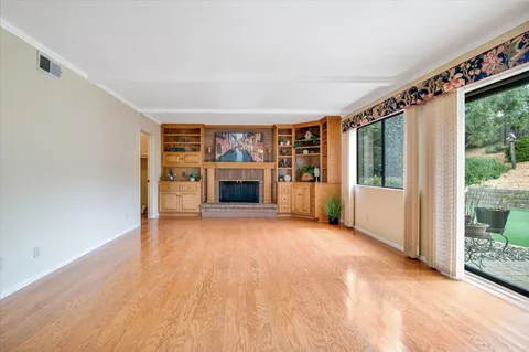 a living room with furniture large window and a fireplace