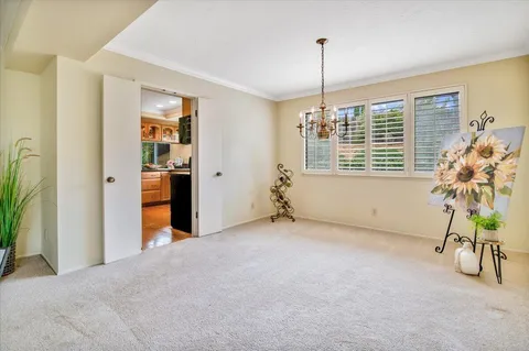 a kitchen with stainless steel appliances granite countertop a refrigerator a sink dishwasher a stove and white countertops with wooden floor