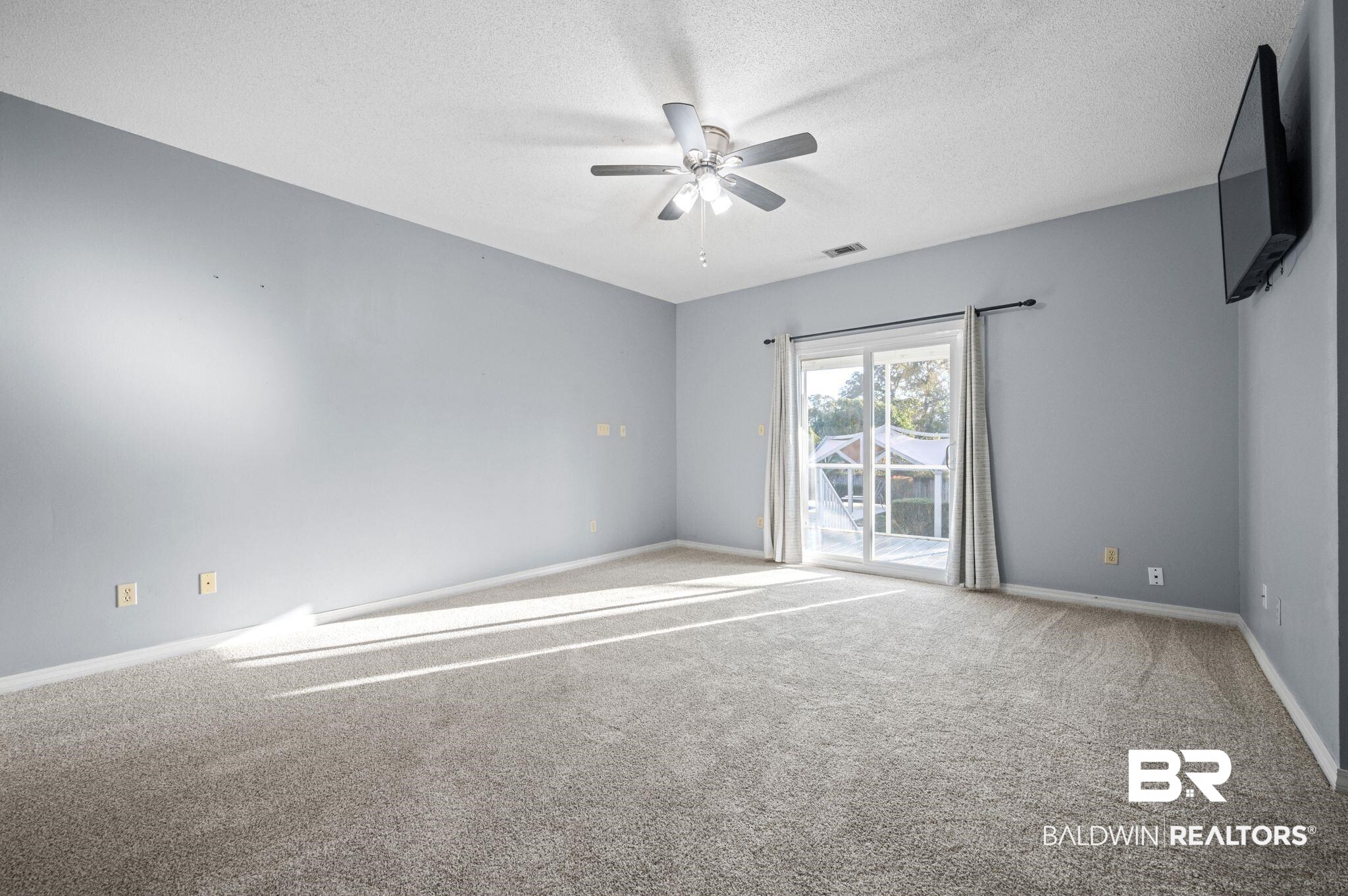 100 Orleans Way Daphne, AL 36526 - Photo 21 of 31 Empty room featuring a textured ceiling, carpet floors, and ceiling fan