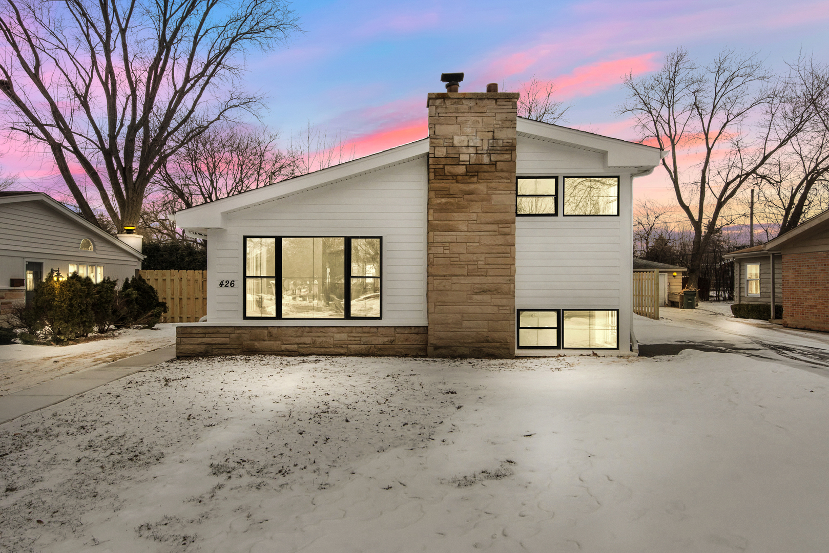426 Shermer Road Glenview, IL 60025 - Photo 1 of 52 a front view of a house with a snow in front of residential house