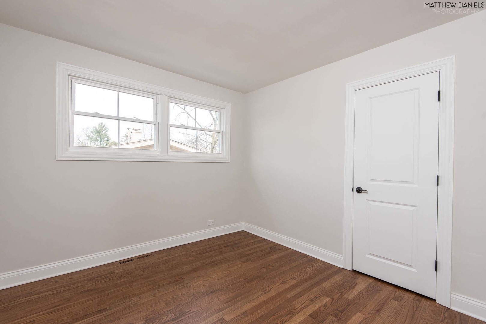 426 Shermer Road Glenview, IL 60025 - Photo 41 of 52 an empty room with wooden floor and windows