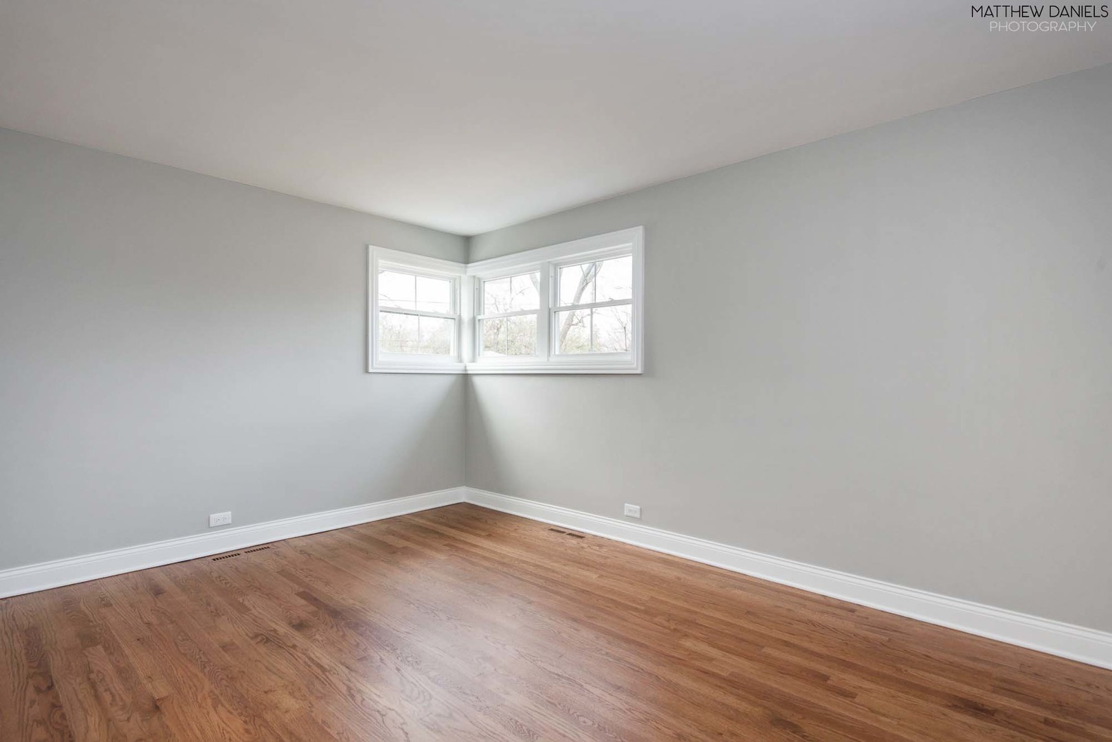 426 Shermer Road Glenview, IL 60025 - Photo 43 of 52 an empty room with wooden floor and windows