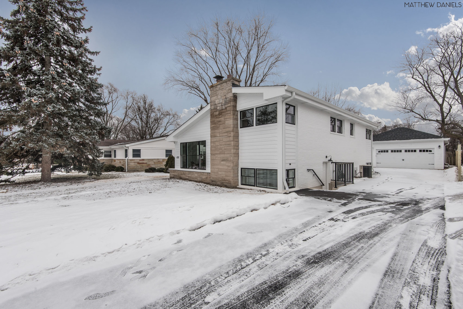 426 Shermer Road Glenview, IL 60025 - Photo 52 of 52 a view of a white house with a snow on the road