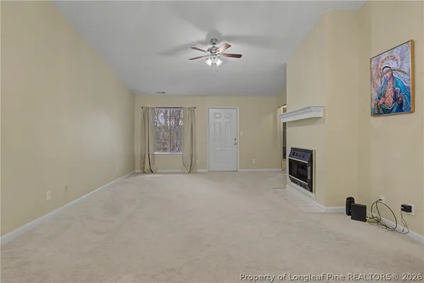 a view of a livingroom with a ceiling fan and window