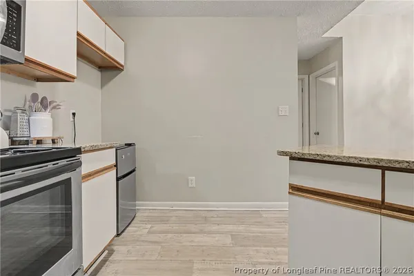 a kitchen with a stove and a microwave