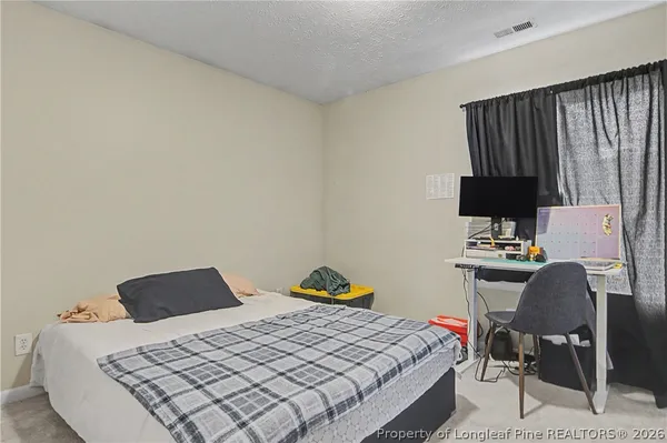 a bedroom with a bed and a chair